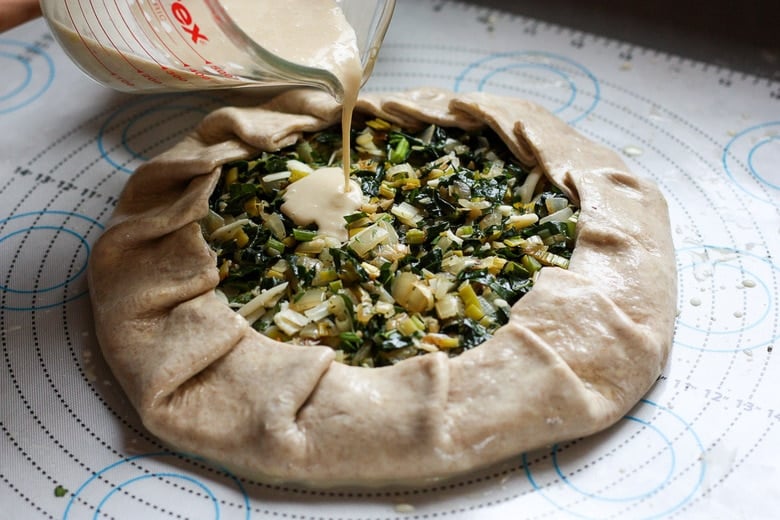 dough with folded up the edges, crimping every 2 inches and egg mixture poured over top of filling.