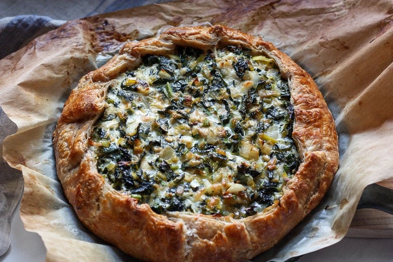 Beautiful and golden Savory Leek Galette with a free-formed tender flakey crust enclosing a succulent filling.