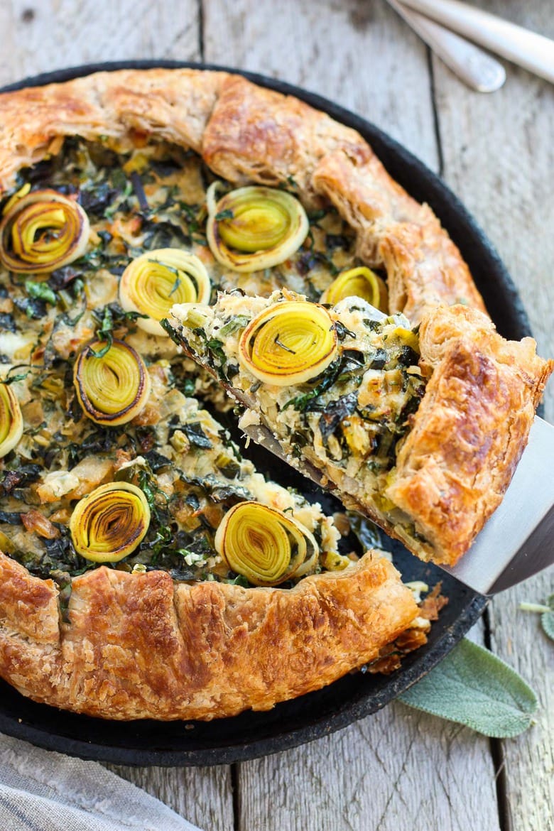 30 Vibrant Healthy Spring Recipes: Beautiful and delicious Savory Leek Galette. Made with a free-formed tender flakey crust enclosing a luscious melt in your mouth succulent filling. Leeks and kale marry with gruyere and mascarpone making the perfect balance of decadent and wholesome! The Galette dough is the secret here! #galette #savorygalette #tart #leeks