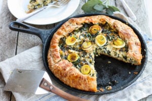 Beautiful and delicious Savory Leek Galette. Made with a free-formed tender flakey crust enclosing a luscious melt in your mouth succulent filling. Leeks and kale marry with gruyere and mascarpone making the perfect balance of decadent and wholesome! The Galette dough is the secret here! #galette #savorygalette #tart #leeks