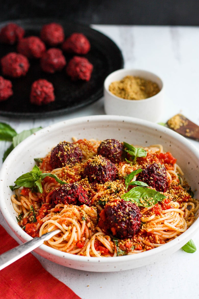 Vegan Spaghetti and Beetballs! A beautiful twist on the comforting familiar classic. Beets, black beans, walnuts and basil make these plant-based meatballs scrumptious and so satisfying. Top with an easy rustic tomato sauce for a meal the whole family will love! #vegan #veganmeatballs #beetballs #spaghetti #veganspaghetti