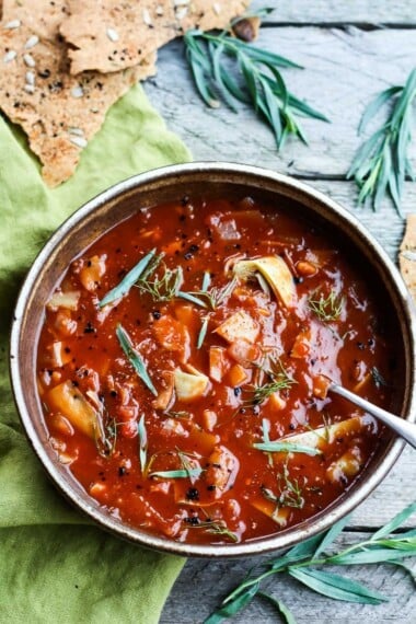 This quick and easy recipe for Tomato Artichoke Soup is made with simple pantry ingredients. Healthy vegan and full of flavor! #tomatosoup #vegansoup #vegantomatosoup