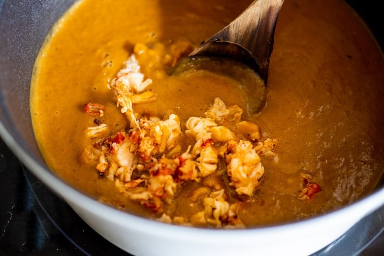 Blend the soup until creamy, then add the lobster.