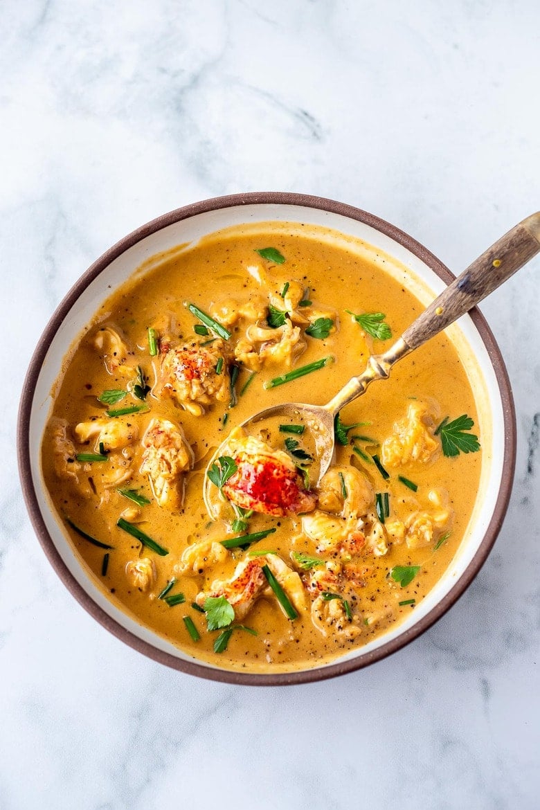 This Lobster Bisque Recipe is made simple and easy with quick homemade lobster stock, big bites of lobster, and a creamy luscious bisque thickened with sweet potatoes. For extra decadence saute the lobster in browned butter infused with garlic.