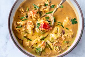 This Lobster Bisque Recipe is kept simple and easy with quick homemade lobster stock, big bites of lobster tail, and a creamy luscious bisque thickened with sweet potatoes. For Extra decadence the lobster is sautéed in browned butter. #lobsterbisque #lobster