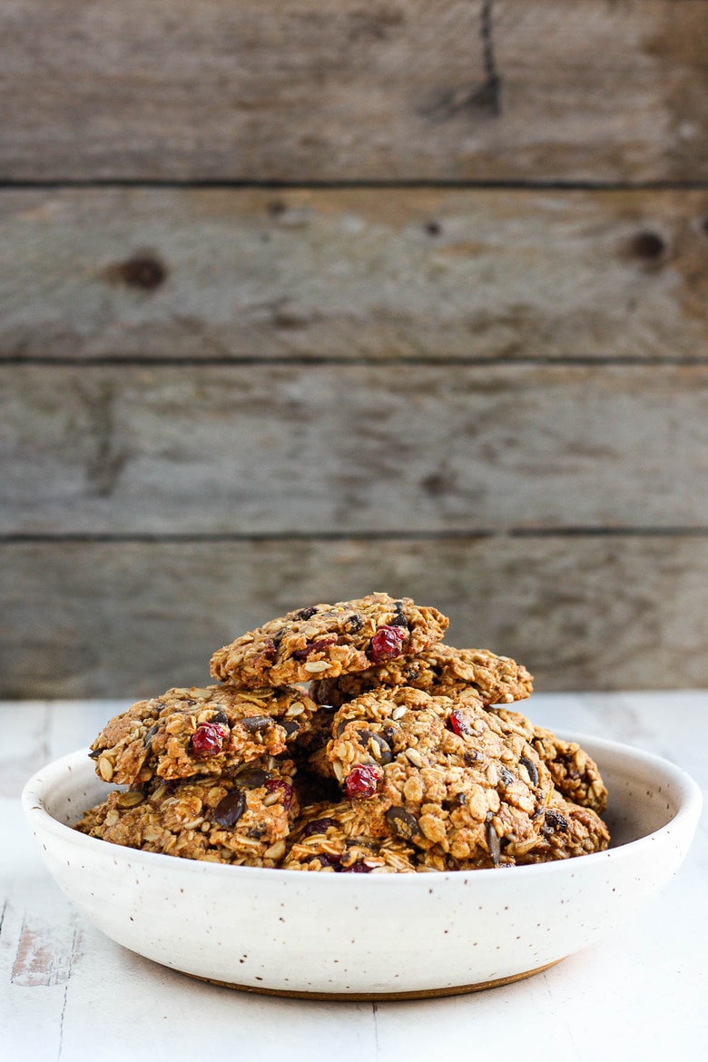 These healthy Breakfast Cookies can be made in under 30 minutes! They are chockfull of flavor and sustenance -filled with oats, seeds, spices and dried fruit they are vegan and deliciously addicting! Perfect for breakfast on the go. #breakfastcookie
