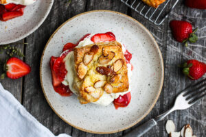 Homemade Strawberry Shortcake from Scratch with golden, flakey biscuits, jammy strawberry sauce, and yogurt whip cream. The perfect American dessert with a twist. This elevated version of the classic is subtly sweet and deeply satisfying. #strawberryshortcake