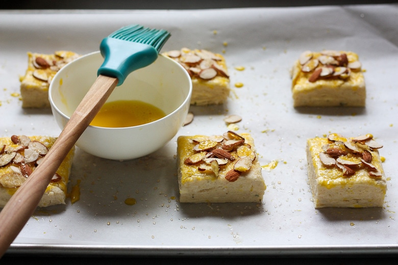 glaze with egg wash and sprinkle with almonds