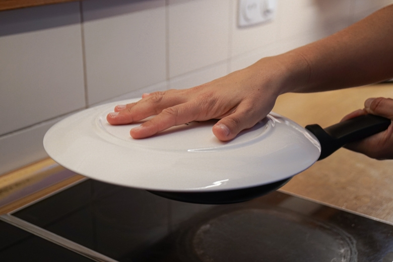 Flip the tortilla placing a plate over the skillet