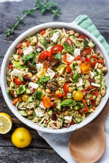 greek pasta salad in a a white bowl.
