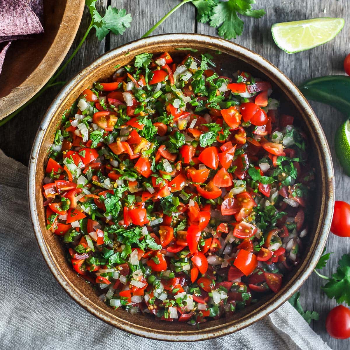 serving bowl with fresh pico de gallo, made with chopped tomatoes, onion, and cilantro. 