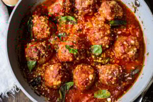 These Italian-inspired Turkey Meatballs with Sun-dried Tomato and Basil can be baked in the oven or pan-seared on the stovetop. Simmer them in your favorite marinara sauce for a few minutes, then serve over pasta or with veggies, for a quick healthy weeknight meal. #bakedmeatballs #turkeymeatballs #italianmeatballs