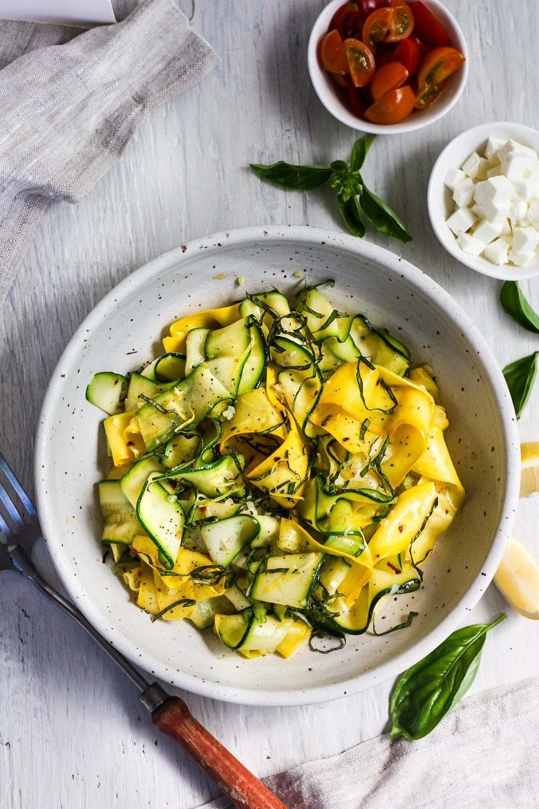 pasta bowl with zucchini ribbons with strips of basil and lemon zest.
