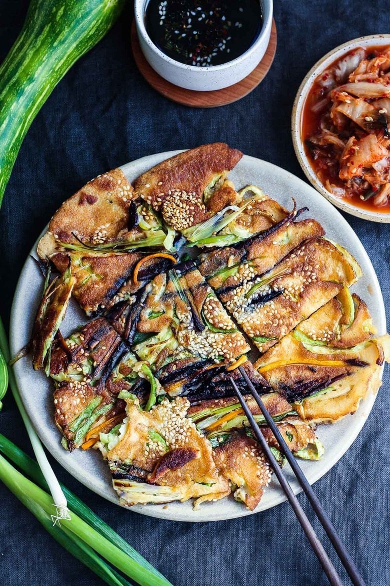 20 BEST Zucchini Recipes | These Korean-inspired Zucchini Scallion Pancakes are a simple tasty treat! No-fuss preparation and ready to serve in minutes. Packed with zucchini and scallions, held together with rice flour and eggs, heavy on the veggies. Seasoned with gochujang pepper chili paste and a touch of rice wine, they are filled with savory flavor.