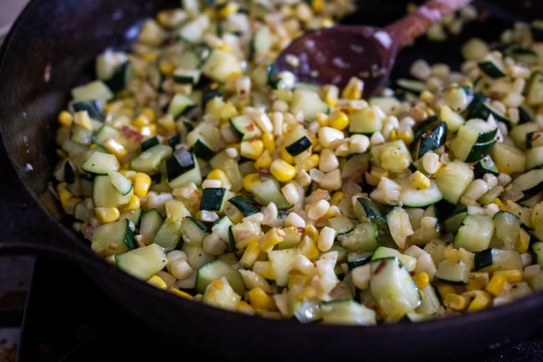 corn added to skillet with sautéed zucchini.