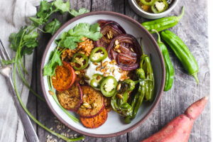 Healthy and flavorful Mexican Rice made with brown rice, topped with sheet-pan roasted yams, red onions, and shishito peppers. Top with pickled jalapeños and pumpkin seeds for a comforting delicious vegan meal. #mexicanrice