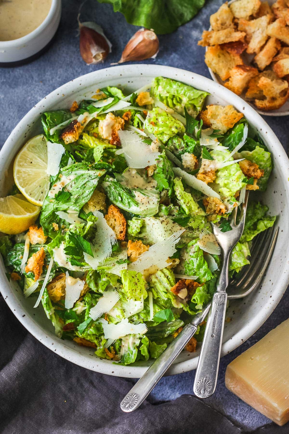 How to make a classic Caesar salad with a creamy tangy dressing, parmesan cheese and homemade croutons.