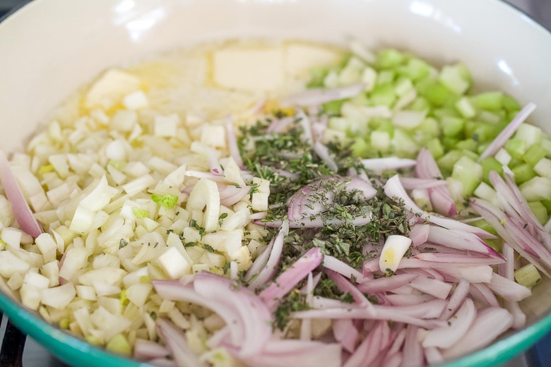 sautéing vegetables, shallot, fennel, celery, and fresh herbs, in butter in skillet.
