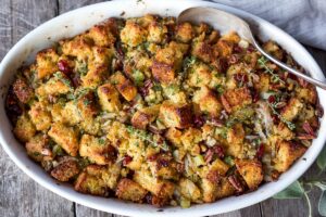Vegetarian Cornbread Stuffing with Fennel Bulb, Dried Cranberries, and Toasted Pecans is richly flavored and soul comforting. The perfect addition to your holiday table. This recipe can easily be made a day ahead of baking! Vegetarian and Gluten Free adaptable.