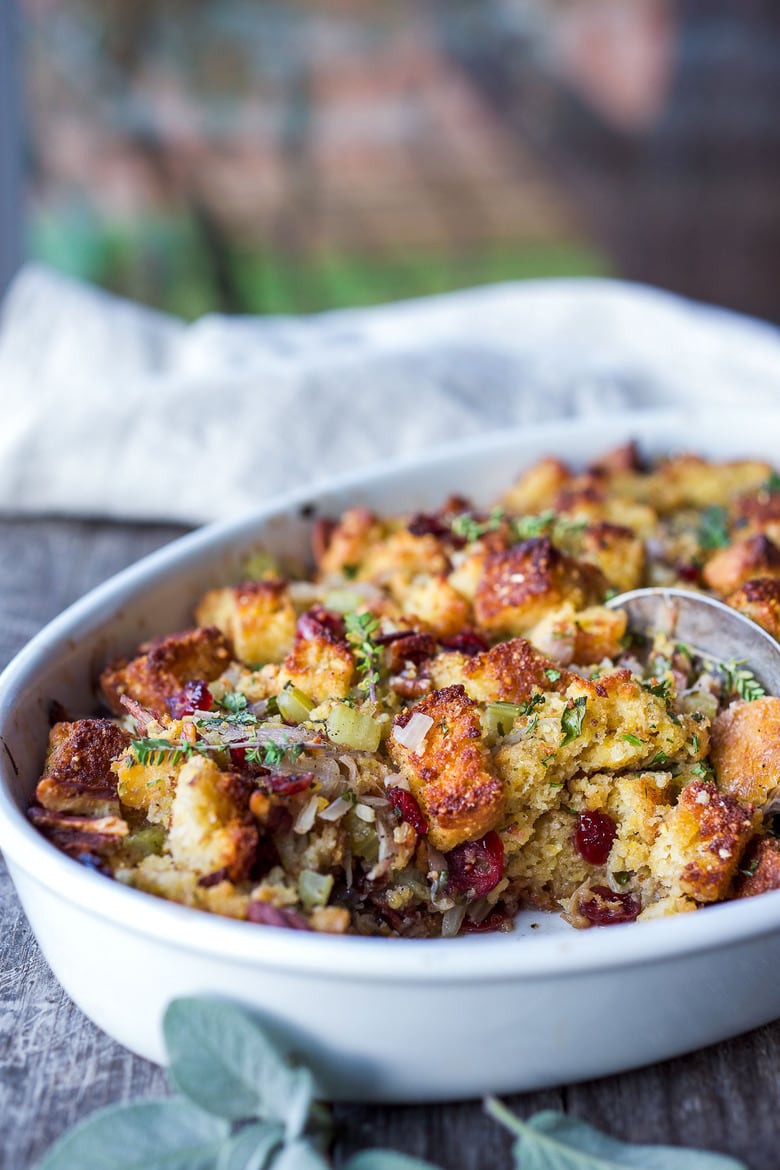 vegetarian cornbread stuffing baking dish with cornbread stuffing with cranberries and fresh herbs.
