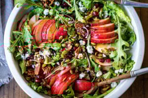 This Pear Salad is the perfect side for a fall gathering or the holiday table. Juicy ripe pears, arugula, spiced nuts, pomegranate seeds, dried currants and gorgonzola are all tossed in a flavorful Vanilla Fig Dressing to create the most delicious balance of flavors.