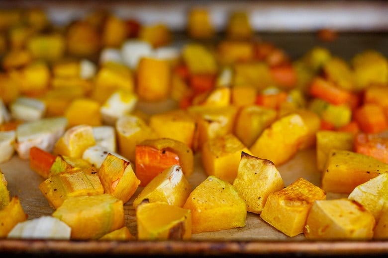 roasted butternut squash, carrot, and parsnip on parchment-lined baking sheet.