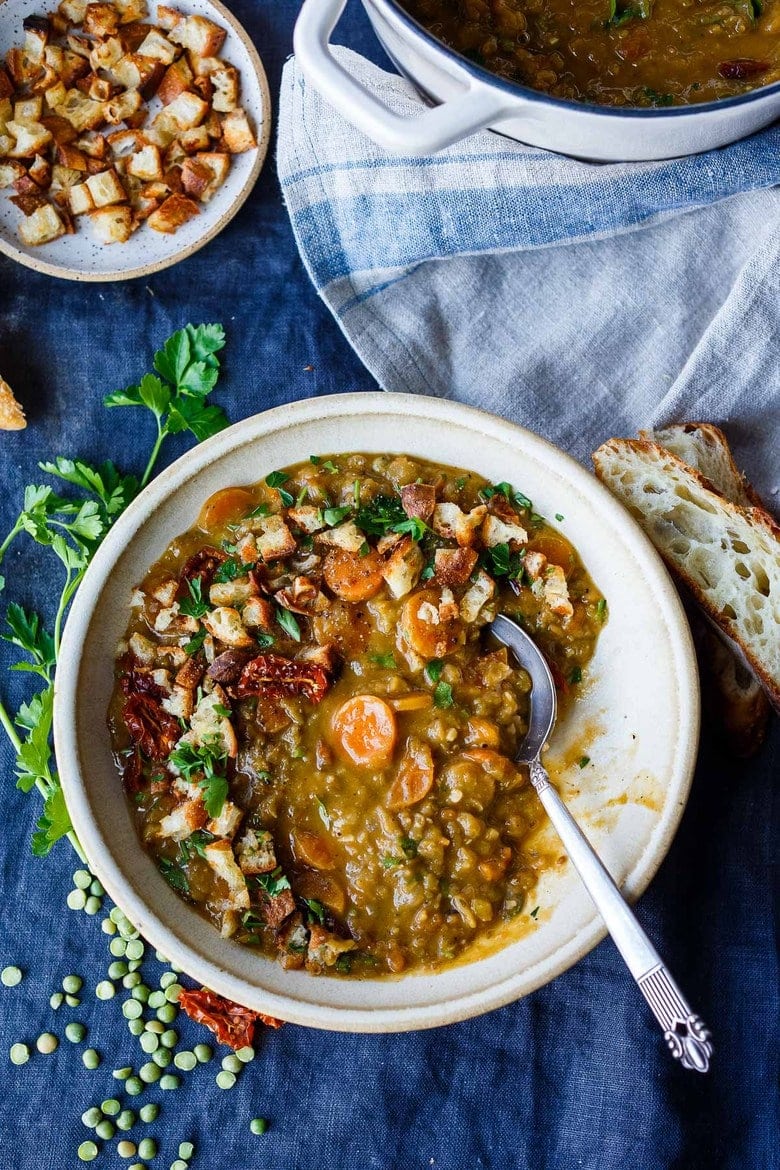 This Mediterranean Split Pea Soup recipe is so savory and flavorful! Simple, clean ingredients create a hearty soup that tastes even better the next day. Vegan & gluten-free.