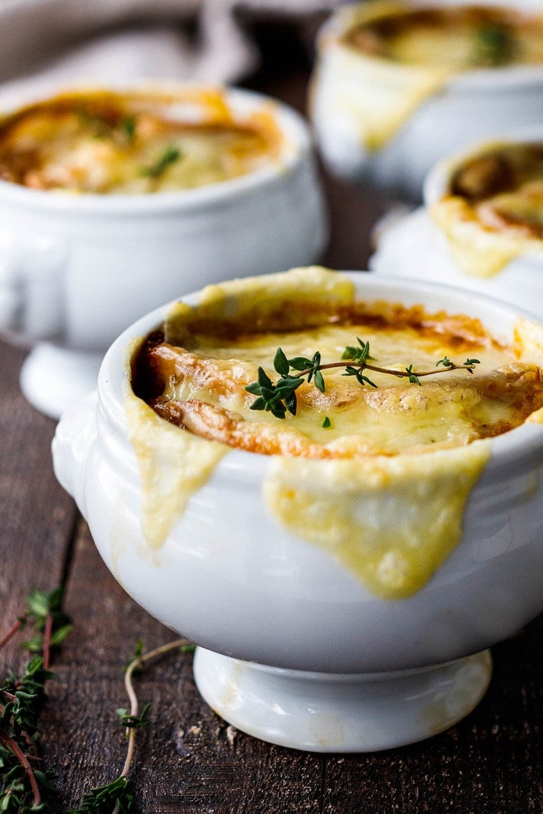 A cozy, comforting, classic recipe for French Onion Soup with caramelized onions in rich deep broth topped with toasty croutons and melted gruyere. Vegan and Vegetarian Adaptable! #frenchonionsoup