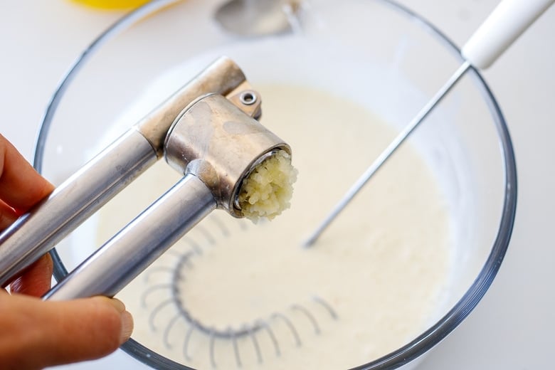 add garlic, using a garlic press.