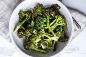 How to make Crispy Oven Roasted Broccoli - perfect as a simple side dish or use to enhance other dishes. Baking in a hot oven yields tender-crisp broccoli in under 30 minutes. Fast and EASY Recipe!
