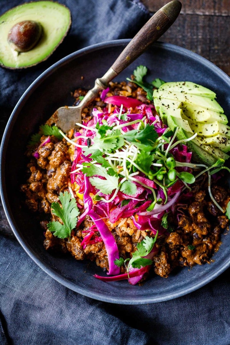 Savory Black Beans baked in a quick and easy Mexican Mole Sauce topped with queso fresco cheese (optional)- serve this as a delicious side dish for your Mexican Fiesta or as a flavorful base for healthy bowls.