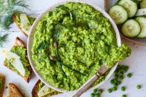 Quick and easy to make, this Spring Pea Pesto is deliciously vibrant with fresh herby flavor. Perfect for a dip, spread or use as a sauce with pasta and buddha bowls. Vegan and gluten free!