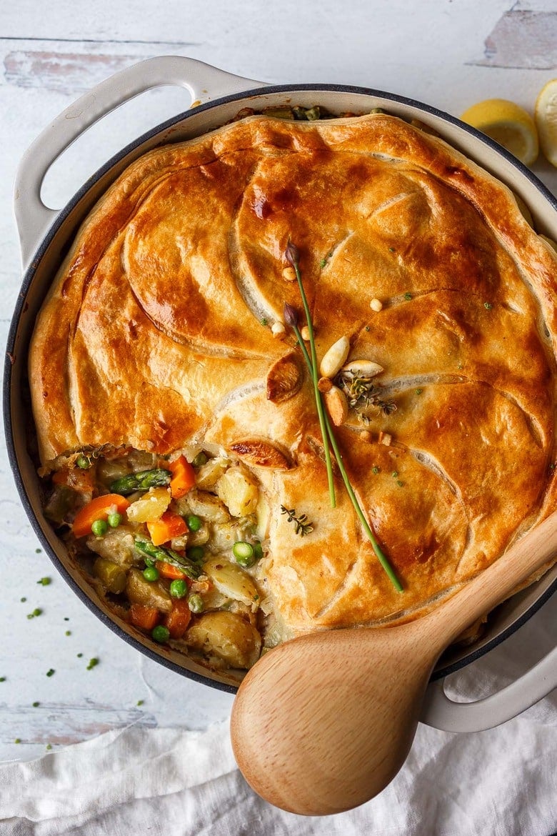 Finished vegetable pot pie recipe, with a wooden spoon. 
