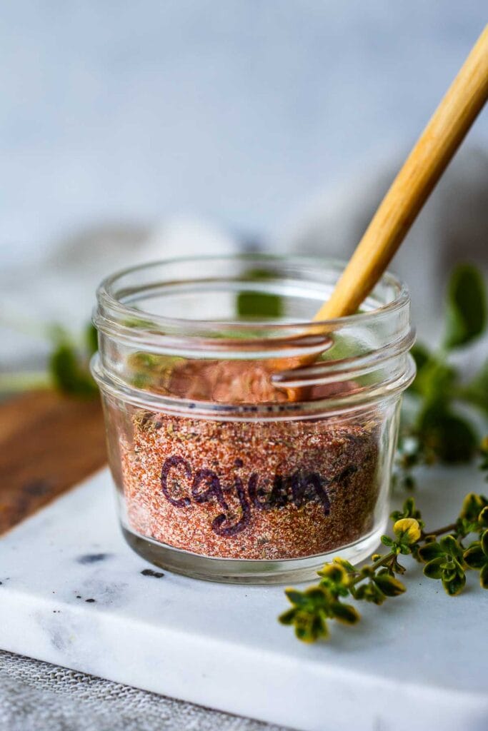 small jar with the text "cajun" filled with homemade cajun seasoning.