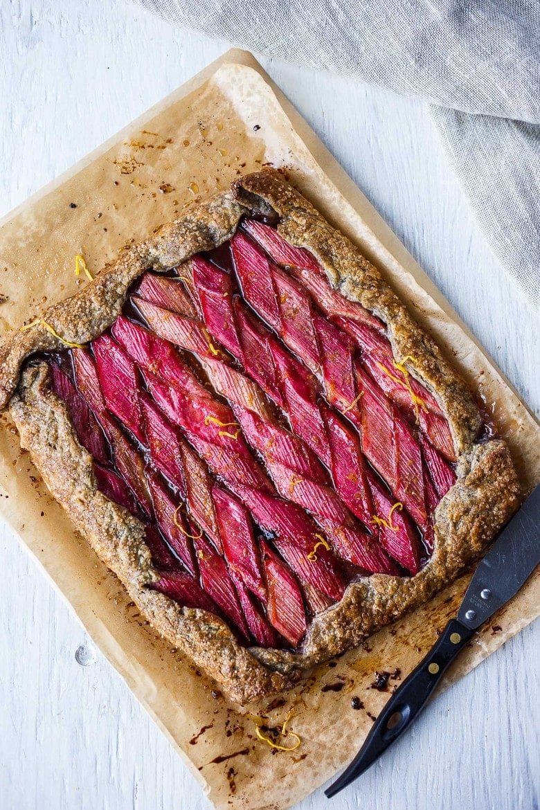 A rustic Rhubarb Tart with lemon, cardamom and vanilla tucked into a flakey free-form buckwheat crust.  Simple, elegant, and delicious!