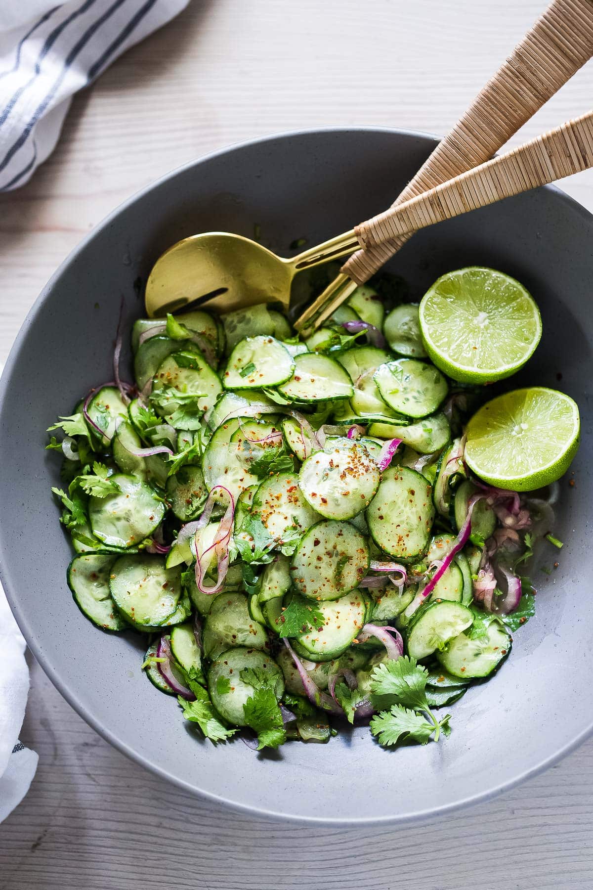 Mexican Cucumber Salad in a grey serving bowl with lime.