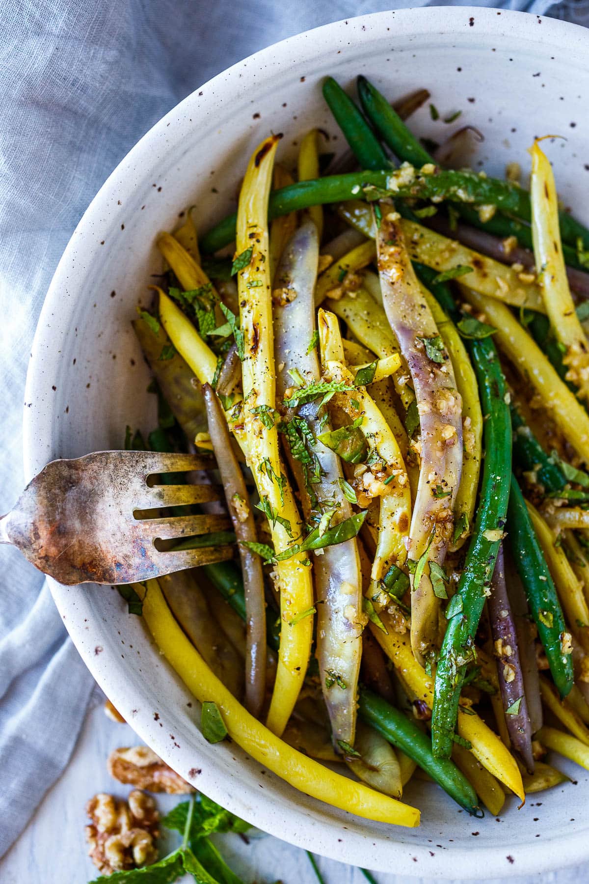 Green beans with Toasted Walnut Vinaigrette, a simple, delicious side dish that will enhance almost any meal. Vegan and Gluten-free.