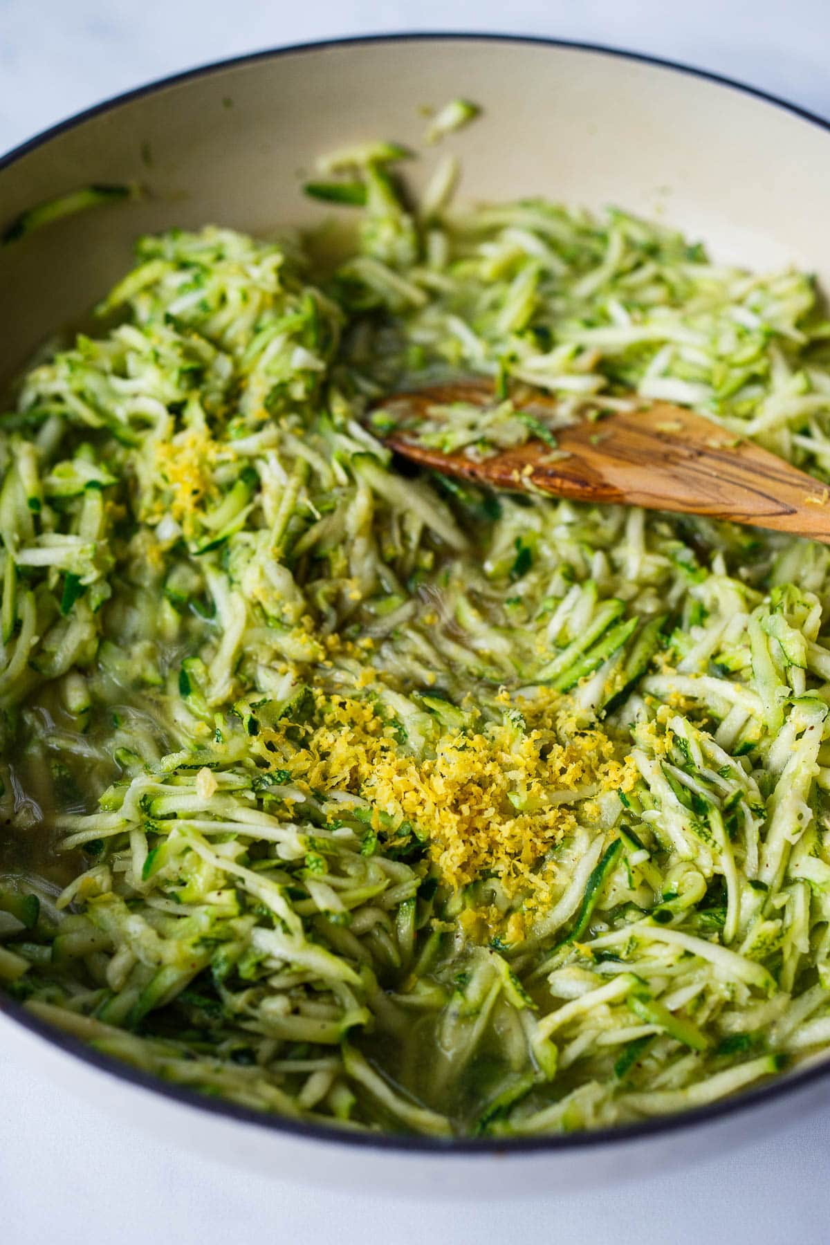 Lemon zest incorporating into zucchini sauce.