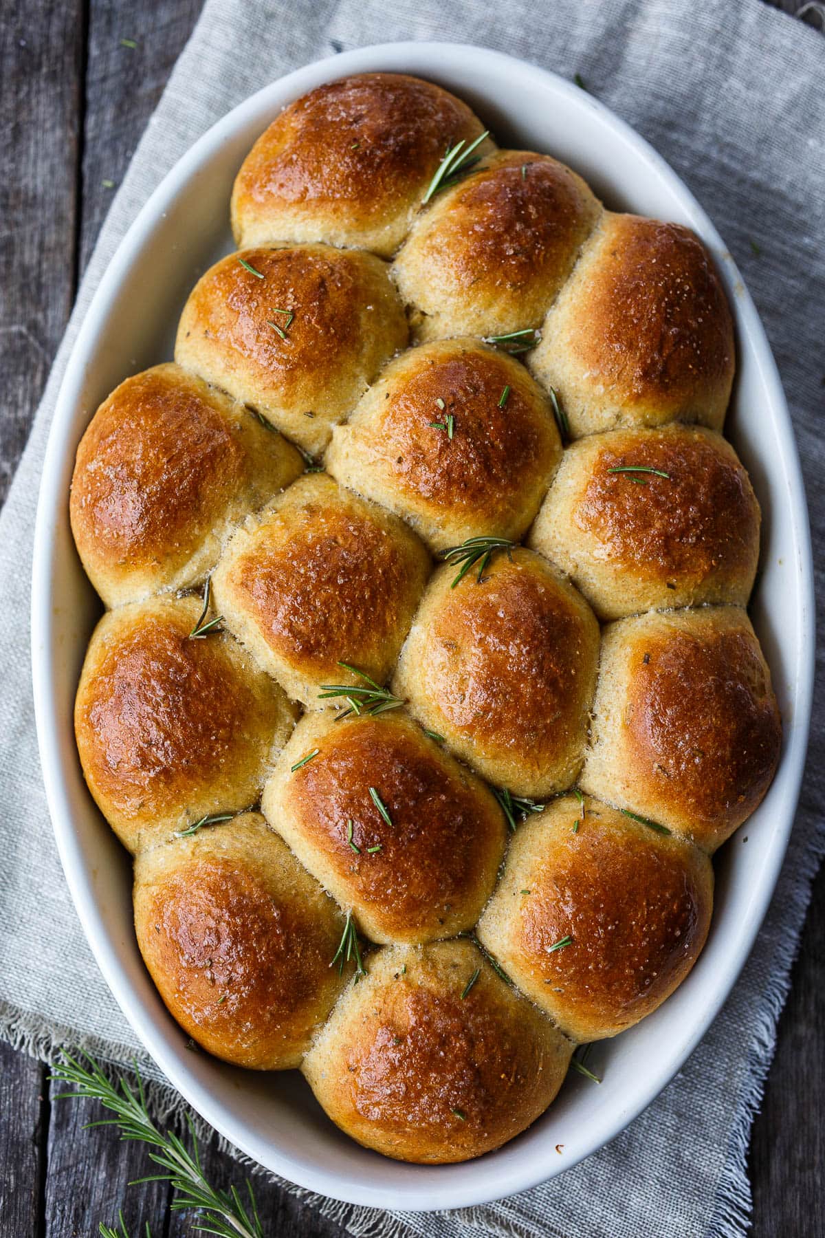 Golden and tender these whole wheat, pull-apart, Butternut Squash Dinner Rolls are flecked with rosemary and completely irresistible. Roasted squash cooked into the roll ensures that they are soft and full of flavor with just a hint of sweetness.