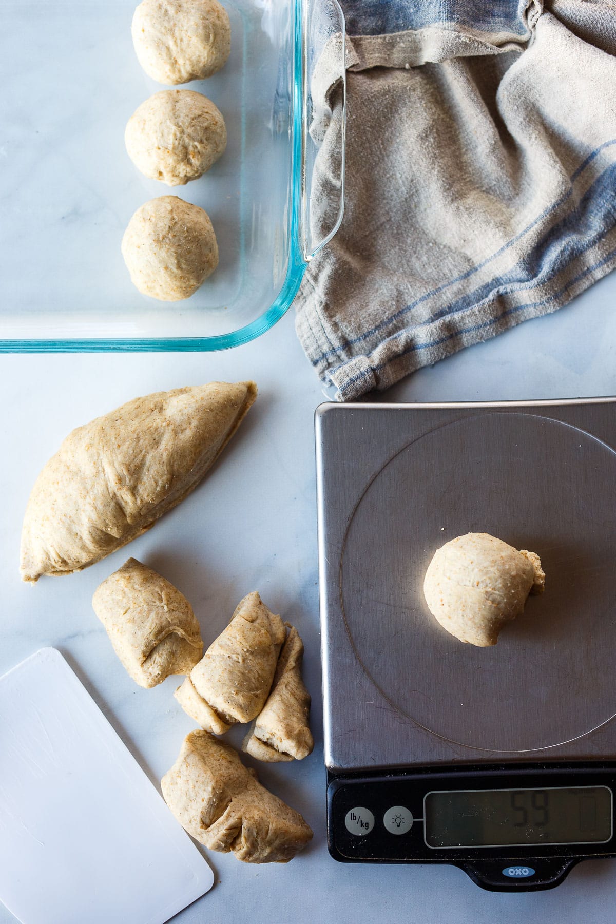 Forming and weighing roll dough.