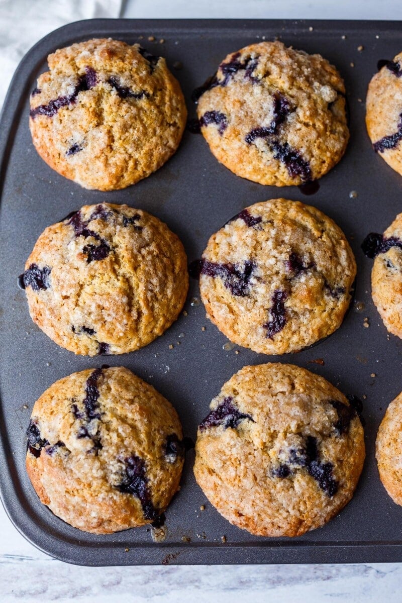 Tender Blueberry Muffins lightly sweetened, enhanced with lemon zest, vanilla and cardamom made with fresh or frozen blueberries. A delicious breakfast or afternoon snack. Gluten-free adaptable.