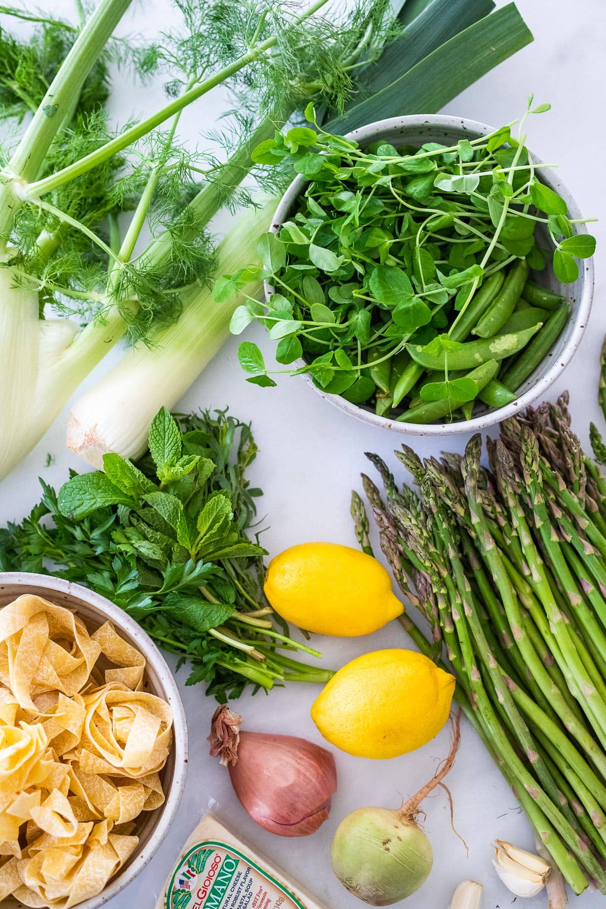 Ingredients in pasta primavera- asparagus, fennel, leeks, peas, fresh herbs, lemon and olive oil. 