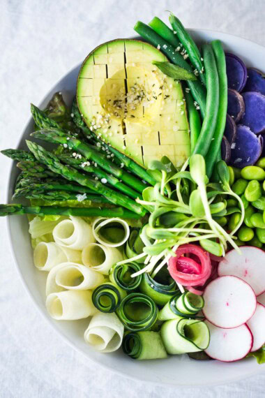 This Green Goddess Bowl features the best of fresh spring produce arranged beautifully over a bed of greens or grains, topped with a creamy vegan green goddess dressing. 
