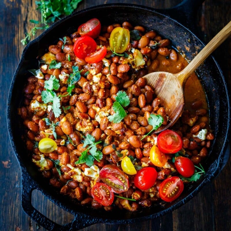 A twist on the classic Frijoles Rancheros- this version is made with pinto beans and homemade enchilada sauce, and crumbled queso fresco cheese, baked in the oven until melty. Vegan-adaptable.