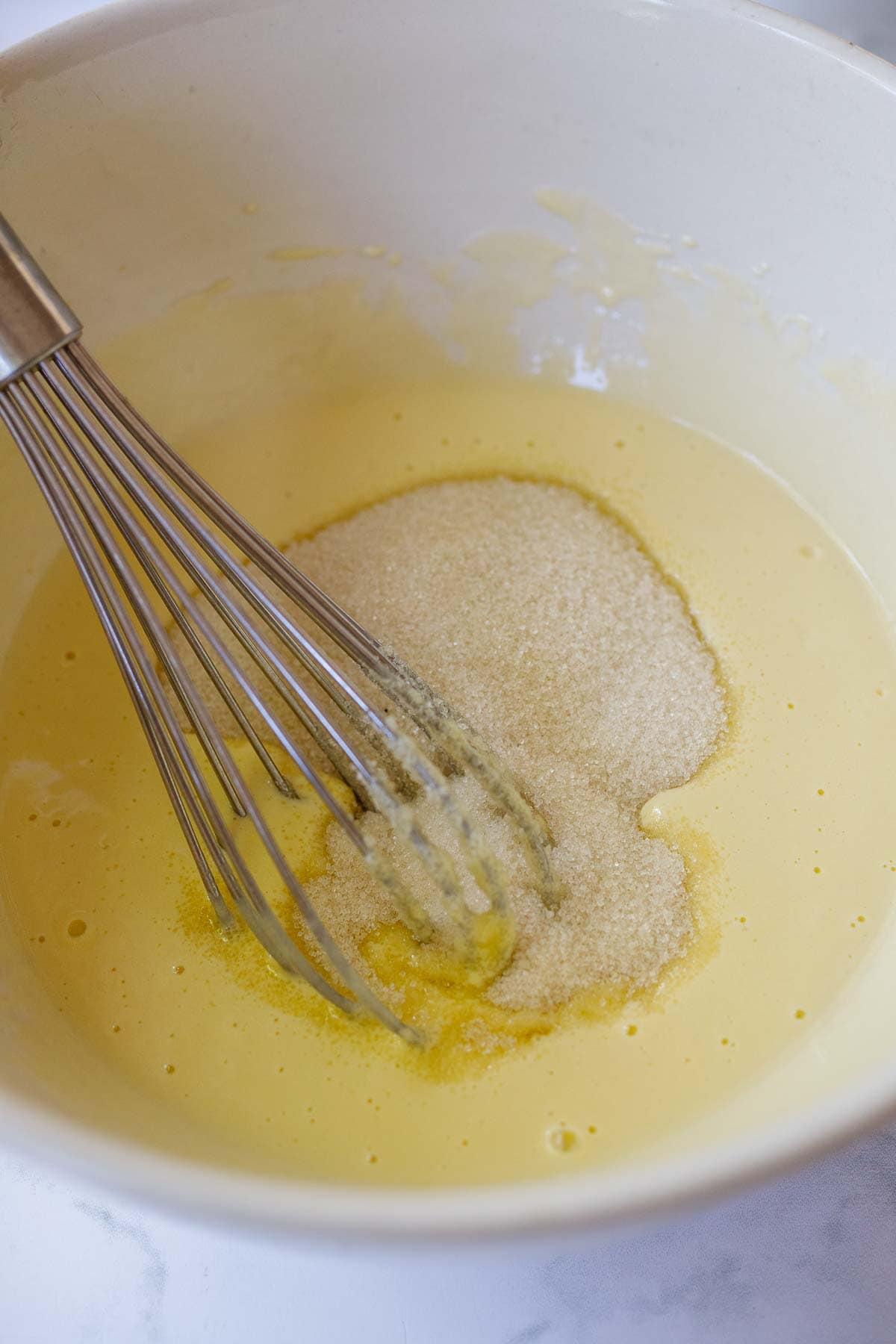 Whisking in the sugar.