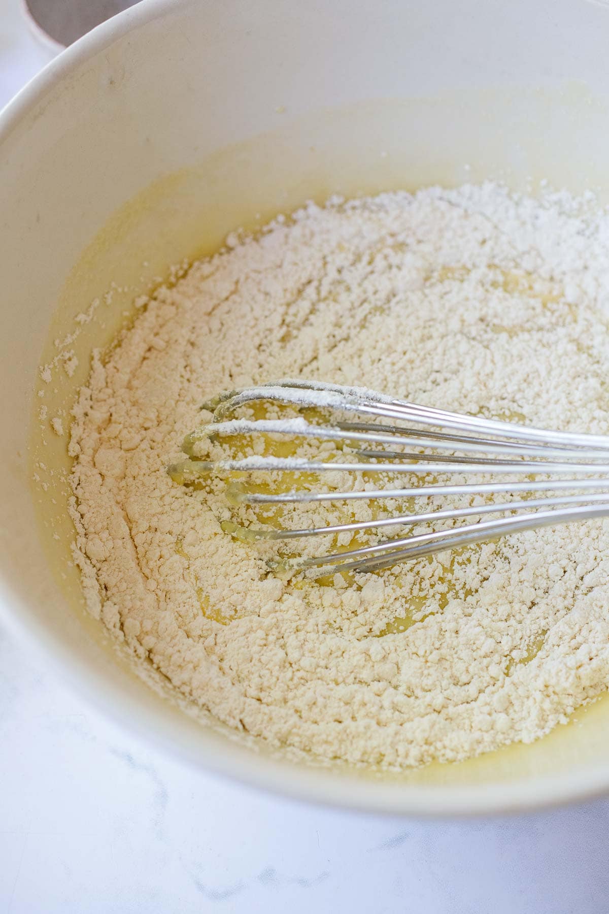 Whisking in the flour.