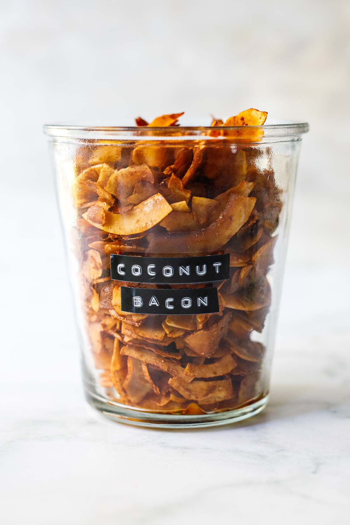 This Coconut Bacon recipe is healthy, crunchy and easy to make in about 15 minutes. A delicious savory, smoky topping for salads, soups, wraps and avocado toast! Vegan and Gluten Free!