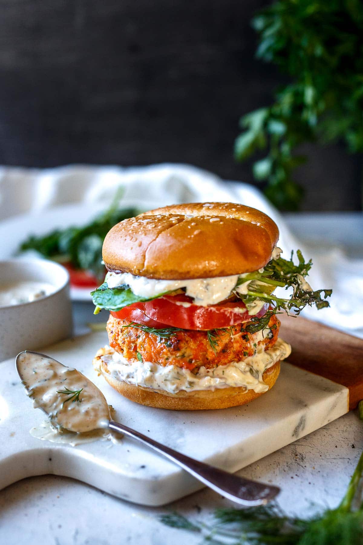 Healthy delicious Salmon Burgers are easy to make with fresh salmon! Grillable and flavorful with the best texture. A perfect summer meal bursting with delicious flavor and healthy omega-3s!