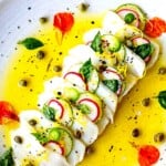 Crudo is easy to make at home and one of those appetizers that will WOW your guests. Think of crudo like Italian-style sashimi- raw fish drizzled with olive oil, flakey sea salt, citrus, and herbs. We'll show you the basic recipe to use as a jumping-off point for your own creations. There are many ways to prepare crudo!