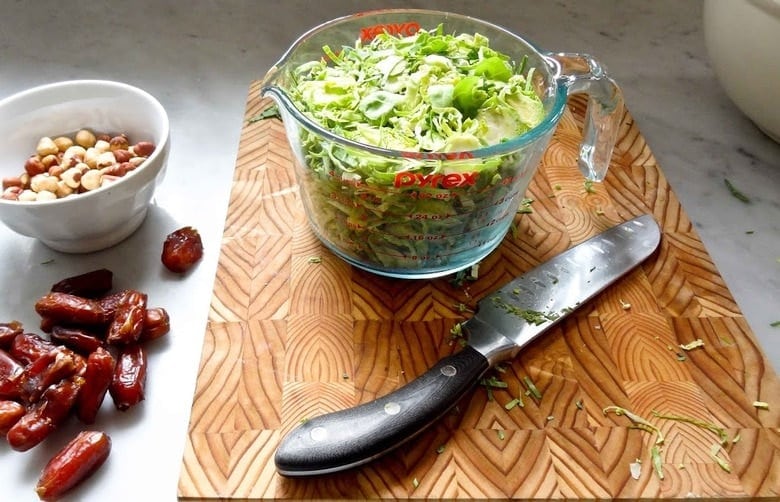 Sliced Brussels Sprouts, dates and hazelnuts for the salad.